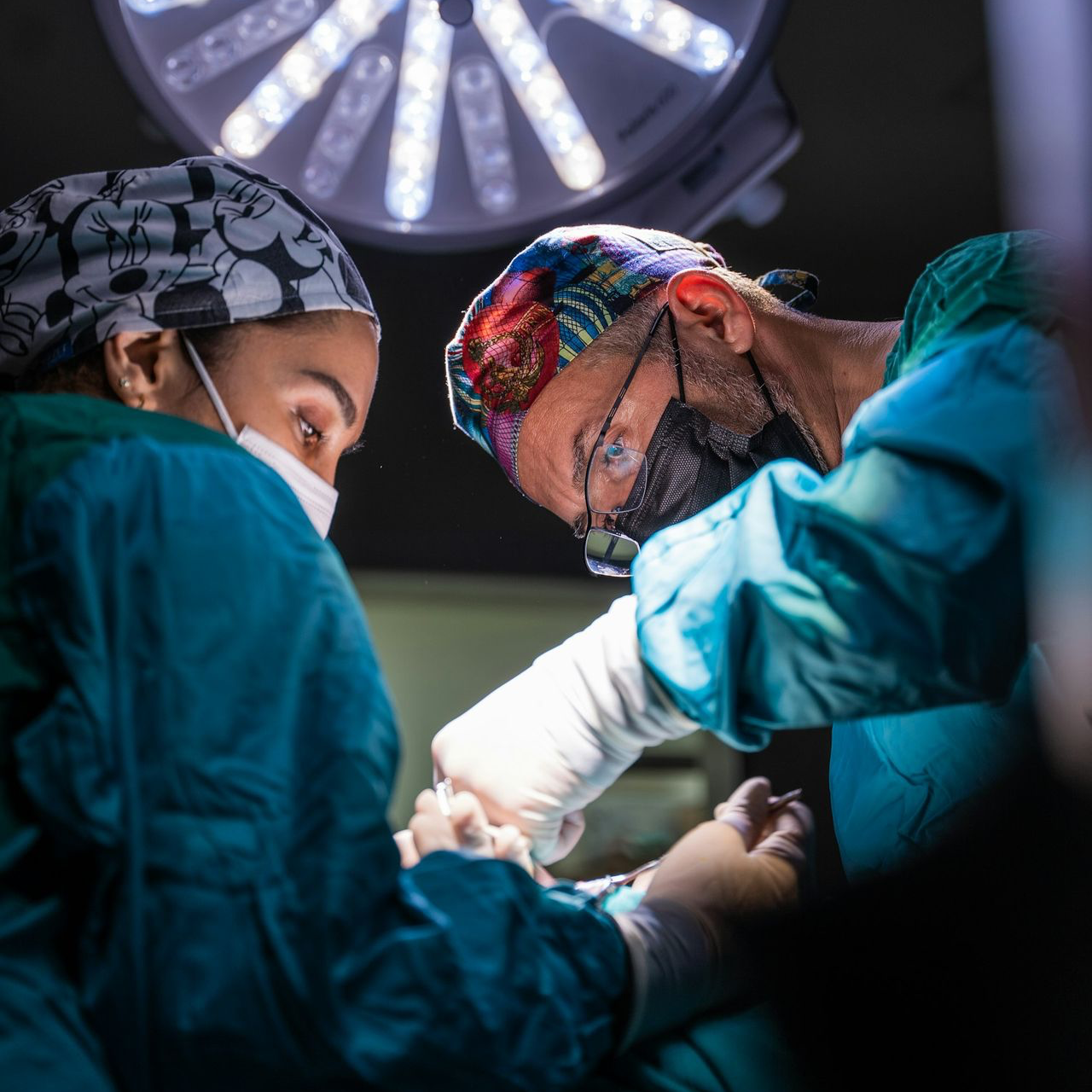 two surgeons performing surgery on a patient in a hospital